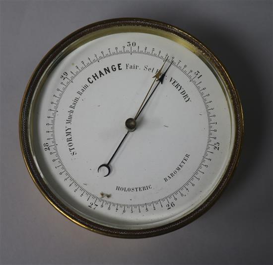 A small brass aneroid barometer